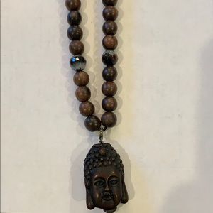 Beaded wooden necklace with Buddha charm.